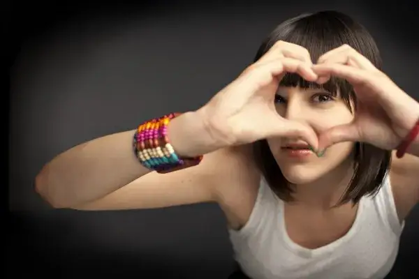 November is National Adoption Month - Girl Making Heart Shape with Her Hands