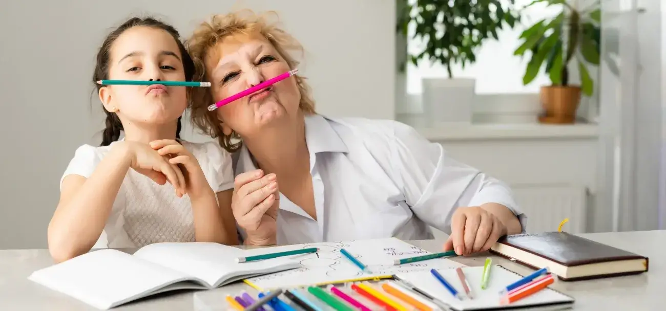 Foster mom and school-aged child having play fun with art supplies.