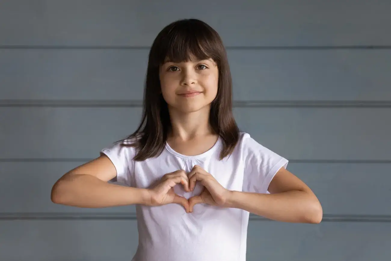 Foster child with a heart on her chest